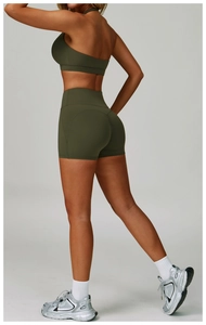 Detail of dark green backless yoga set showing high-waist shorts and butt-lifting seams
