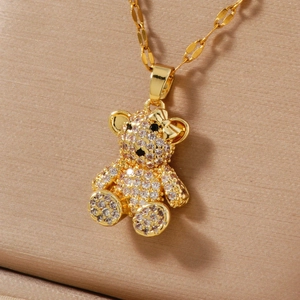 Macro shot of gold teddy bear pendant with sparkling zircon micro-pave and bow detail