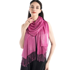 Close-up detail of shiny pink scarf fabric featuring elegant fringe and silver glitter silk