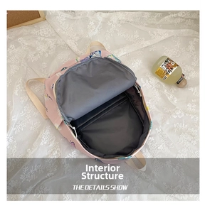 Detail view of the spacious internal storage compartment in pink daisy print backpack