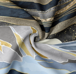 Macro shot of abstract mountain tapestry fabric with silk texture and gold metallic details