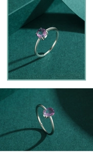Macro detail of S925 silver ring featuring an oval pink-purple gradient gemstone inlay