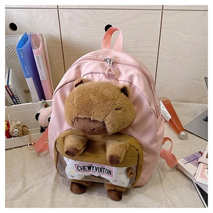 Pink nylon backpack detail with a cute plush capybara doll holding a bone accessory