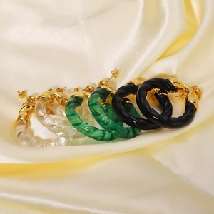 Chic acrylic spiral hoop earrings in green, black, and clear with gold-tone accents