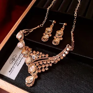 Vintage French gold jewelry set with crystal necklace and teardrop earrings in a velvet box