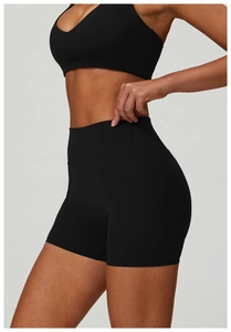 Detail of high-waisted black yoga shorts showing the sculpting matte high-elastic fabric