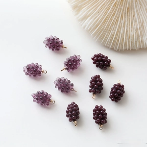 Detailed view of DIY mini resin grape charms with gold hanging rings for jewelry making