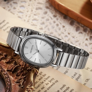 Elegant silver oval quartz watch with bamboo-style steel strap on a vintage background