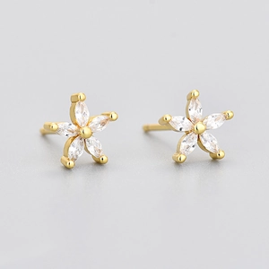Macro shot of gold floral earrings featuring five marquise-cut marquise stones