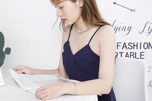 Polished silver titanium steel necklace and bangle set worn by a fashion model