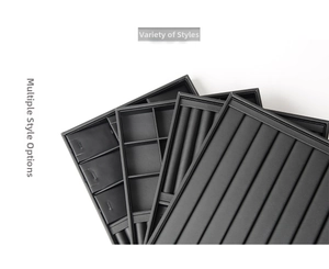 Stack of black PU leather jewelry trays featuring multiple compartments and ring slots