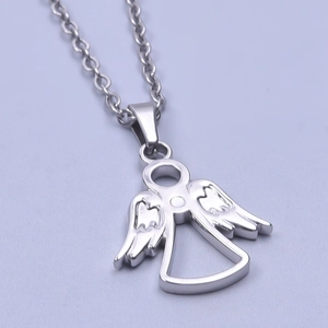 Macro shot of a silver angel pendant necklace on a textured light purple fabric background