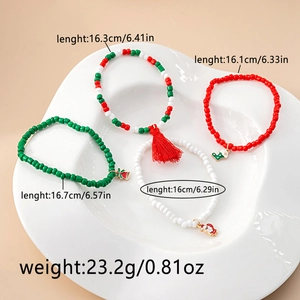 Close-up of colorful Christmas charms with bells and Santa motifs on beaded bracelets
