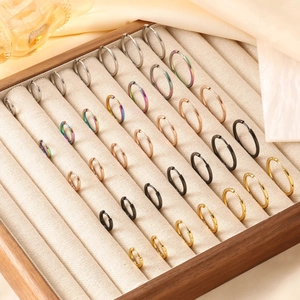 Polished stainless steel hoop earrings in silver, gold, black, and rose gold finishes
