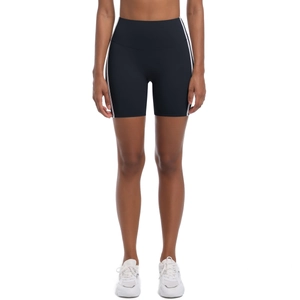 Detail of high-waisted black yoga shorts with white side stripes and tummy control waistband