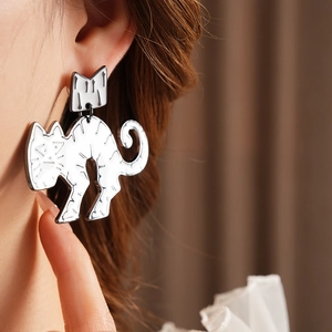 Close-up of minimalist silver cat earrings in a two-piece design worn by a model