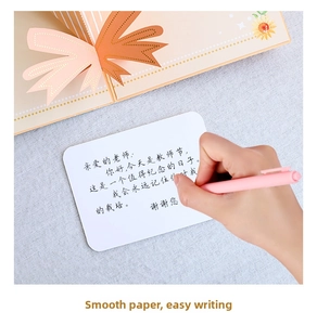 Close-up of 3D folding greeting card with sunflower detail and pen on writing surface