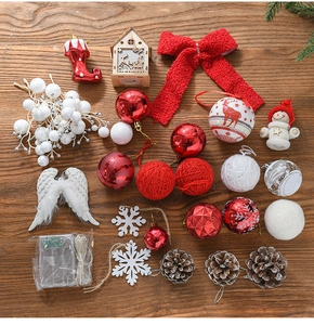 Flat lay of festive Christmas tree ornaments with pine cones, bows, and lights on wood