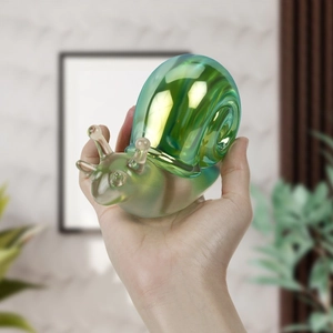 Macro shot of an iridescent snail craft figurine with a translucent pearlescent finish