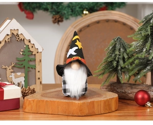Close-up of Halloween gnome with wizard hat and plaid body in festive forest decor