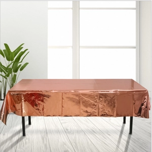 Detailed view of glossy rose gold metallic tablecloth in a modern interior setting