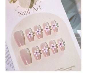 Detail of pink false nails with 3D white flowers and tiny sparkling rhinestones