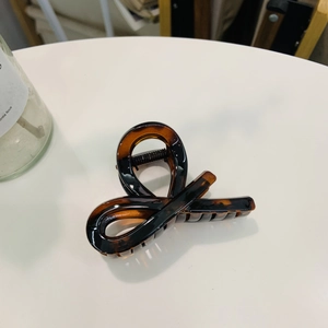 Macro shot of tortoiseshell claw clip with twisted design and strong metal spring