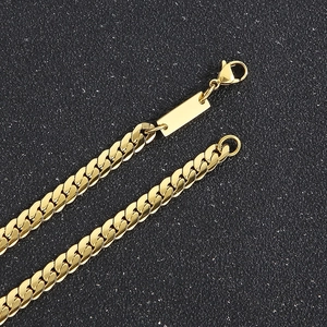 Close-up of gold stainless steel Cuban chain necklace with lobster clasp and engravable plate
