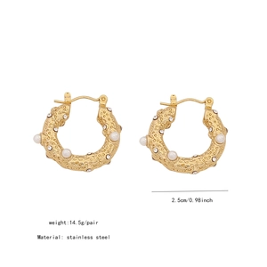 Detailed close-up of C-shaped gold stainless steel earrings with pearls and rhinestones
