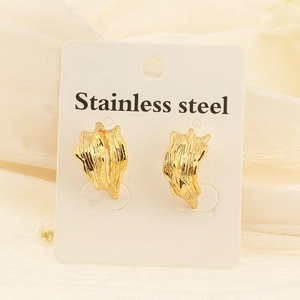 Detail shot of golden C-shaped stainless steel earrings with irregular wrinkled texture