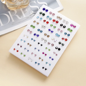 Set of 50 pairs colorful crystal stud earrings arranged on white display foam board
