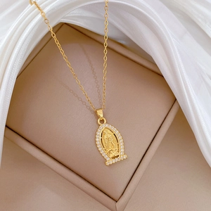 Detailed close-up of Virgin Mary oval pendant with shimmering crystals on silk