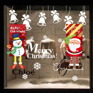 Festive Christmas window decals featuring Santa, snowman, bells and snowflakes on glass