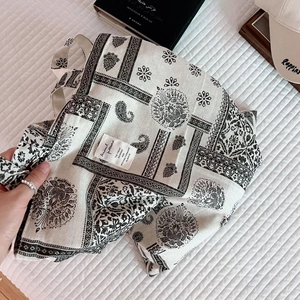 Detailed macro of the vintage canvas tote bag with ethnic black and white floral prints