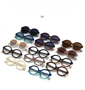 Flat lay of retro round sunglasses in various colors like black and tortoiseshell