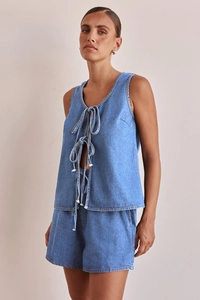 Detailed macro view of dark blue denim fabric texture and high-waist drawstring stitching