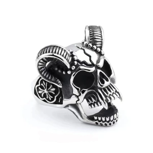 Macro shot of gothic ram skull ring with curved horns and detailed silver texture