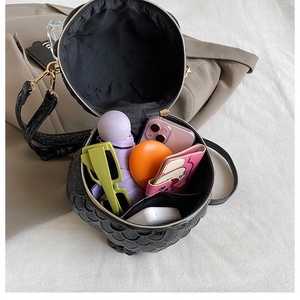 Detailed interior of black owl-shaped crossbody bag showing large storage capacity