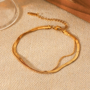 Detail of 18K gold plated double-layer anklet with flat snake and round bead chains