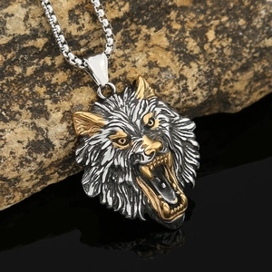 Detailed view of bicolor Viking wolf head pendant in silver and gold stainless steel finish