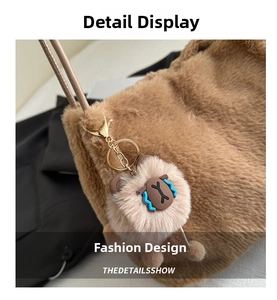 Detail of brown faux fur shoulder bag with cute plush bear pendant and gold hardware