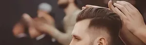 Detail of barber fade comb creating textured men's haircut with gradient side effect