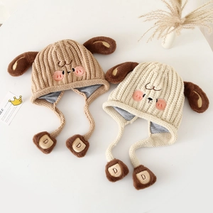 Detail of children's knit puppy hats with 3D ears and embroidered cartoon faces