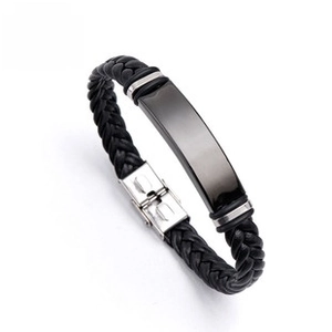 Detail of black braided leather bracelet with polished gunmetal plaque and silver clasp