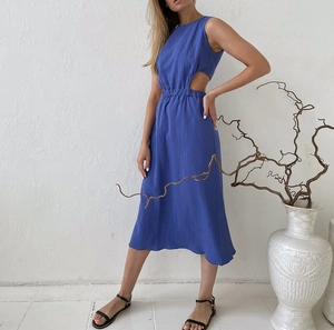 Close-up of blue crinkled dress showing waist cut-out detail and textured fabric