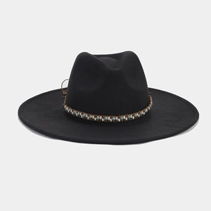 Detailed view of black wide-brim felt hat featuring ethnic beaded band decoration