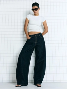 Women high-waisted wide-leg dark blue jeans with white T-shirt on minimalist grid