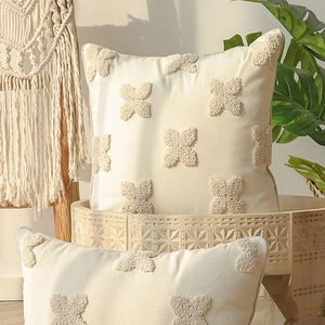 Bohemian style square pillow case with embroidered daisy floral pattern on cream fabric