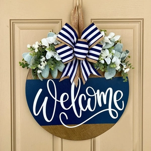 Blue and wood Welcome door hanger with striped bow and artificial greenery foliage
