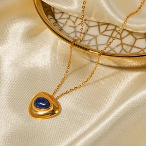 Detailed close-up of a gold-plated titanium necklace with blue lapis lazuli on silk